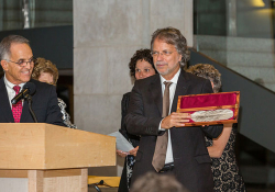 Mia Couto receiving the Neustadt feather. Photo by Vanesssa Rudloff.