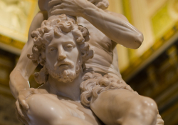 A photographic detail from a sculpture of a beaded male figure