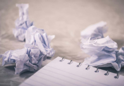 Pieces of paper wadded up next to a pad