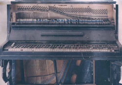 A photograph of a dilapidated piano