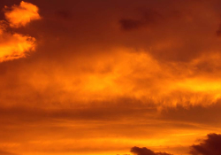 A sky at sunset, a thin blanket of orange clouds lightly covering it