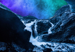 A river flows into the mouth of a darkened cave over rocks, creating a froth. The sky outside the cave is lit up with an aurora borealis