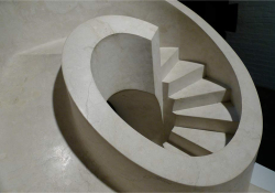 A sculpture from above of a curved staircase that leads down to nowhere