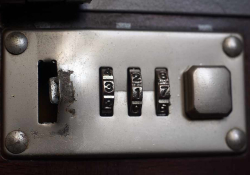 A close-up view of a combination lock on a briefcase