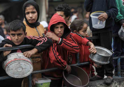 A woman cues up with two children, each holding a metal basin amid a crowd of refugees