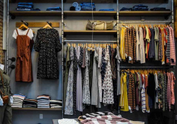 A well-organized closet that is open and takes up a whole wall