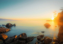 A photograph of sunrise coming up over Lake Baikal