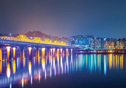 A city skyline reflected in a bay at night