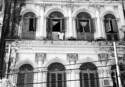 A black and white photograph of the front of a tenement building