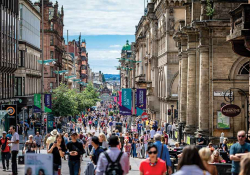 A photograph of a busy street, filled with people, in Glasgow