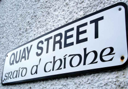 A photograph of a sign that reads (in English) Quay Street with the Gaelic translation printed below