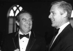 A black and white photo of Octavio Paz and William Banowsky dressed in suits and talking