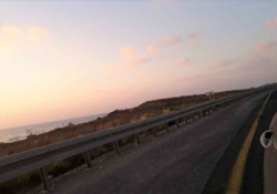 A photograph of a road as seen from a car window