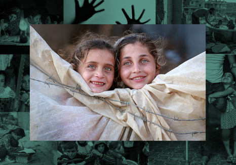 Photo by Fadi Thabet of two young Palestinian girls looking over a tent surrounded by barbed wire
